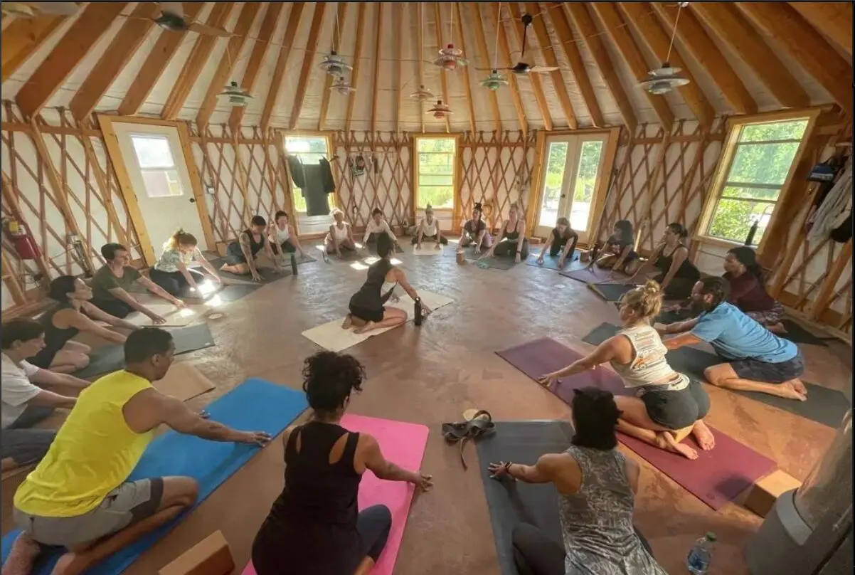 A group of people sitting in a circle doing yoga.